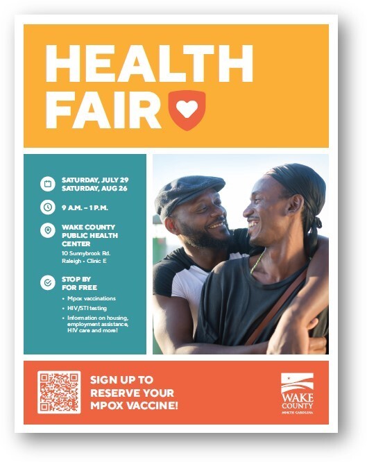 Two people hugging giving information regarding a Health Fair Event
